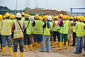 Group of construction workers assemble at the open space.